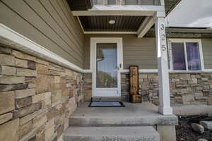 Welcoming entry featuring a stone facade and durable horizontal siding