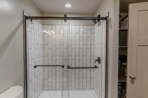 Shower enclosure featuring clear glass sliding doors and matte black hardware