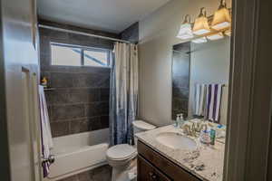 Bathroom featuring a full tub and shower with dark subway tile surround