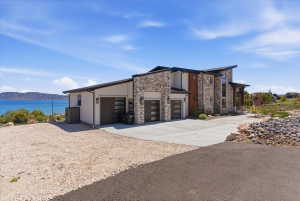 Contemporary multi-level residence featuring stone and stucco exterior finishes