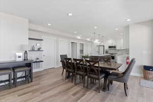 Open concept dining area featuring wood-finish flooring and recessed lighting