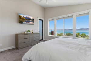 Expansive windows showcasing a serene lake and distant mountains