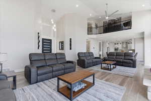 Spacious living area featuring high ceilings, wood-finish flooring, and a modern open-concept design