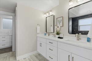 Dual vanity with white cabinetry and integrated sinks