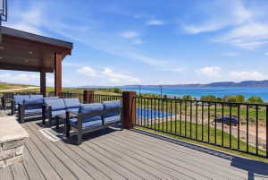 Expansive outdoor deck featuring wood-finish flooring and a black metal railing