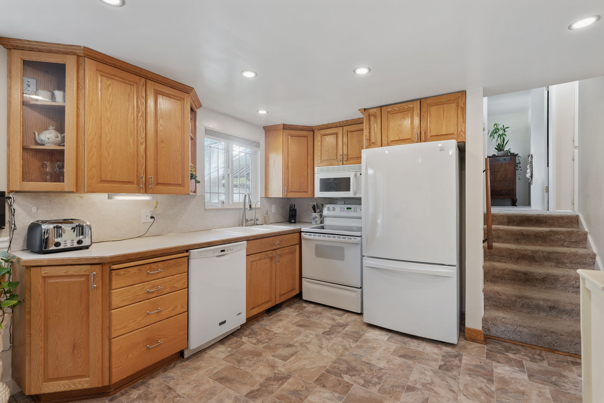 Kitchen/Dining. Can Lights! Updated flooring. Natural Light. Access to back deck. Access to attached garage/workshop.