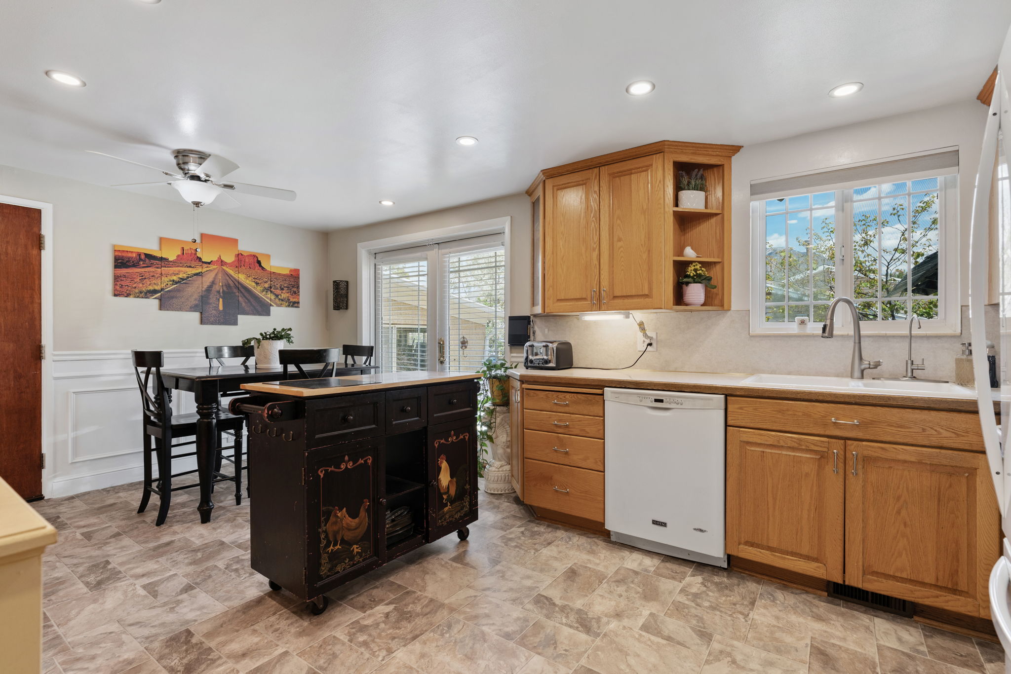 Kitchen/Dining. Can Lights! Updated flooring. Natural Light. Access to back deck. Access to attached garage/workshop.