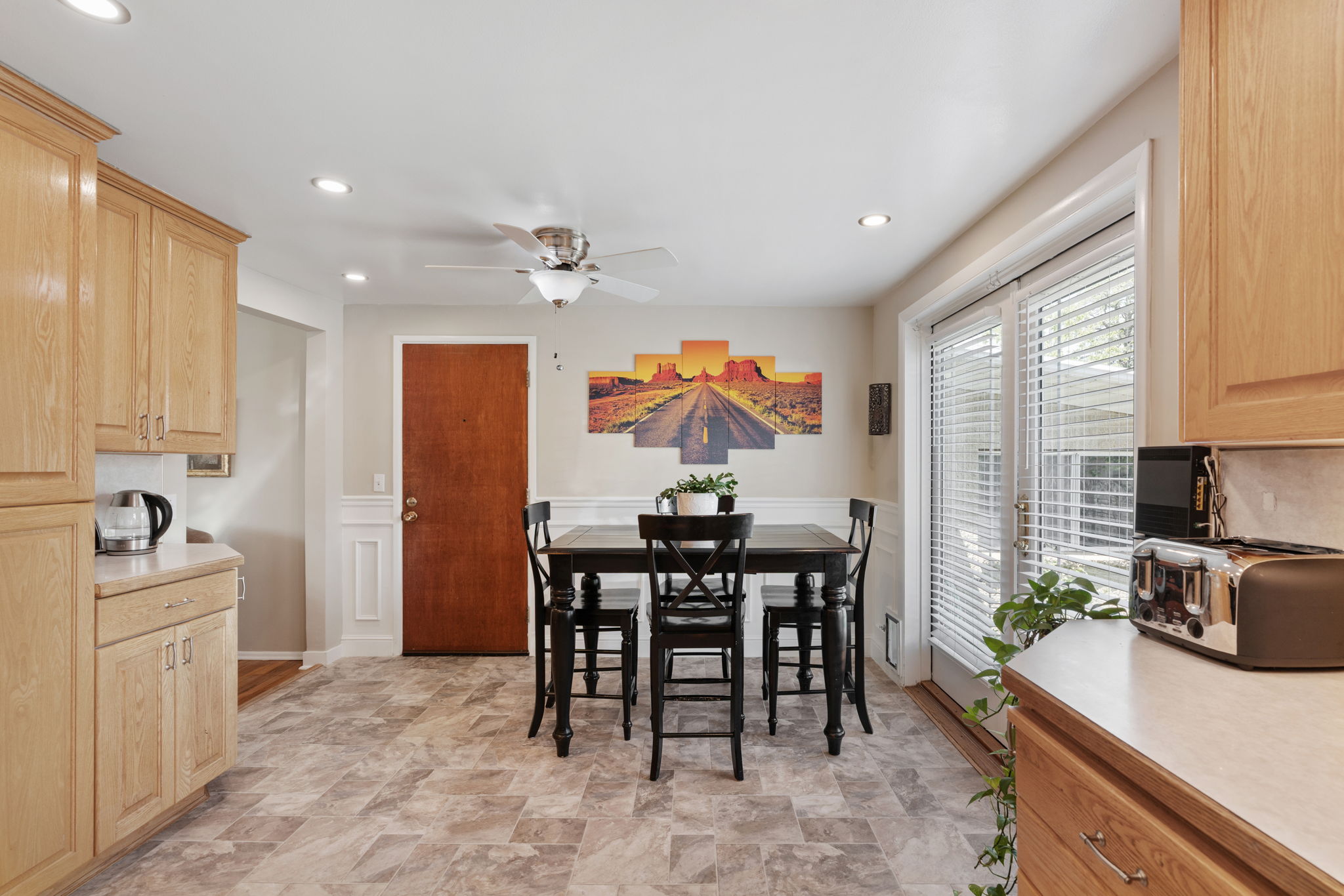 Kitchen/Dining. Can Lights! Updated flooring. Natural Light. Access to back deck. Access to attached garage/workshop.