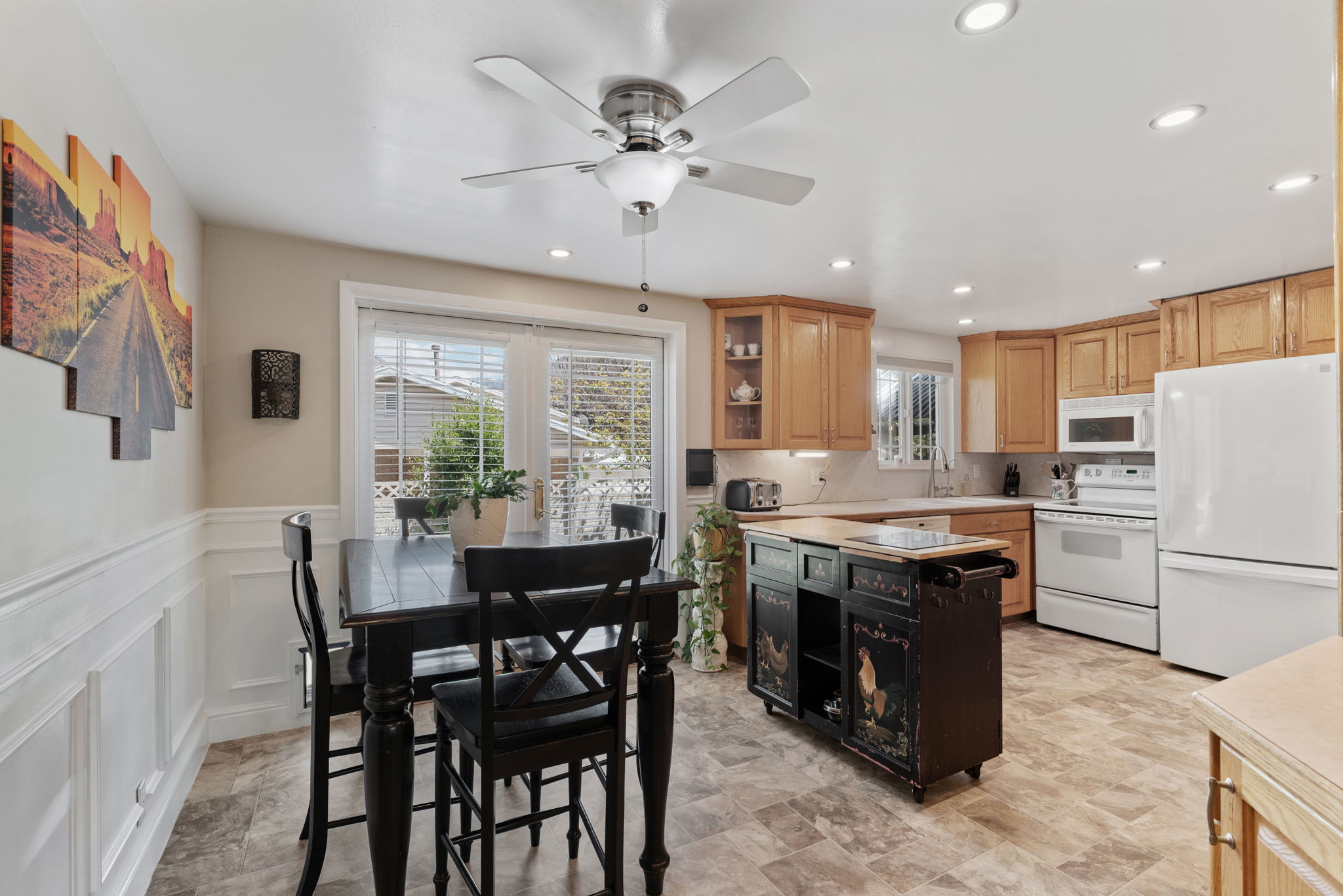 Kitchen/Dining. Can Lights! Updated flooring. Natural Light. Access to back deck. Access to attached garage/workshop.
