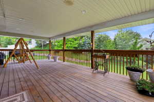Expansive wood-finish deck with a full overhead covering and recessed lighting