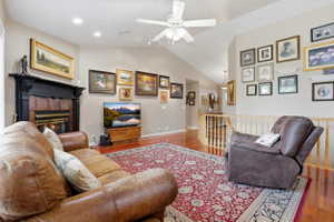 Spacious living area featuring high vaulted ceilings, recessed lighting, and rich wood-finish flooring