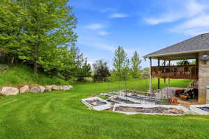 Expansive backyard featuring a lush lawn and established trees