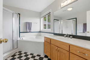 Double vanity with oak finish cabinetry, white countertop, and integrated sink