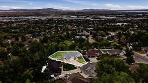 Aerial perspective highlighting the property's corner lot position and landscaped yard