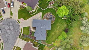 Expansive property featuring a cul-de-sac location, paved driveway, mature trees, manicured lawns, and terraced garden beds