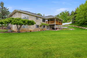 Expansive green lawn bordering a two-story residence with a brick exterior