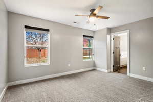 Primary Bedroom - Neutral gray walls complementing textured carpeting