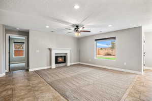 Living area featuring a modern fireplace with a white mantel and mosaic tile surround