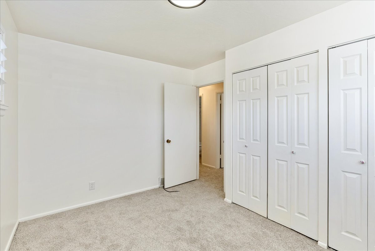 Light-colored carpeting complementing white walls and trim
