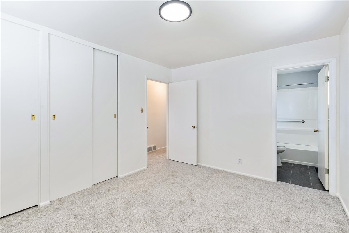Neutral tone walls with light-colored carpeting