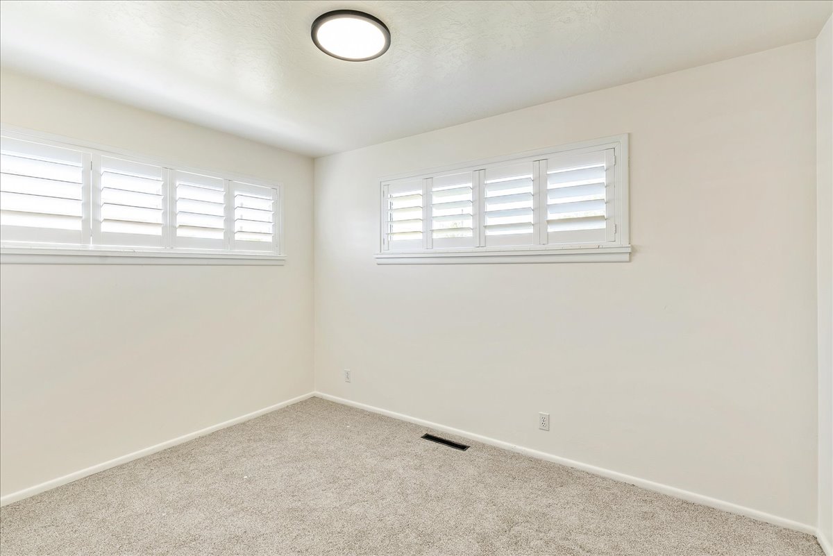 Neutral-toned walls complement the light-colored carpeting