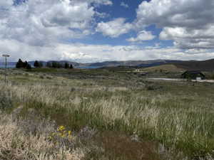 Expansive undeveloped acreage with varied terrain and distant water features