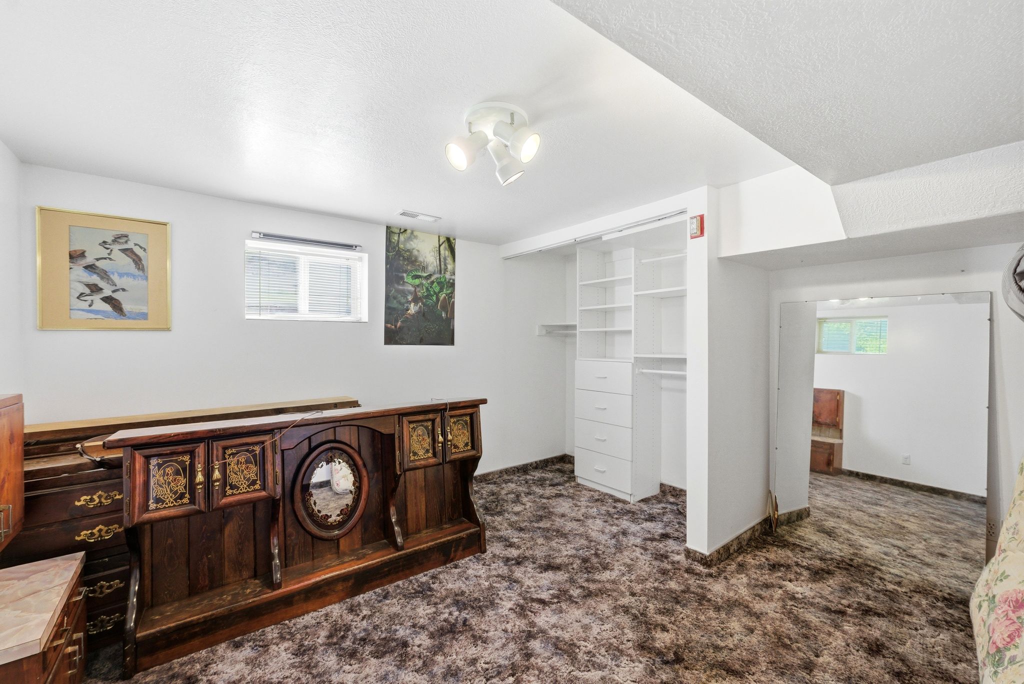 Room featuring wall-to-wall carpeting, recessed window, and white walls