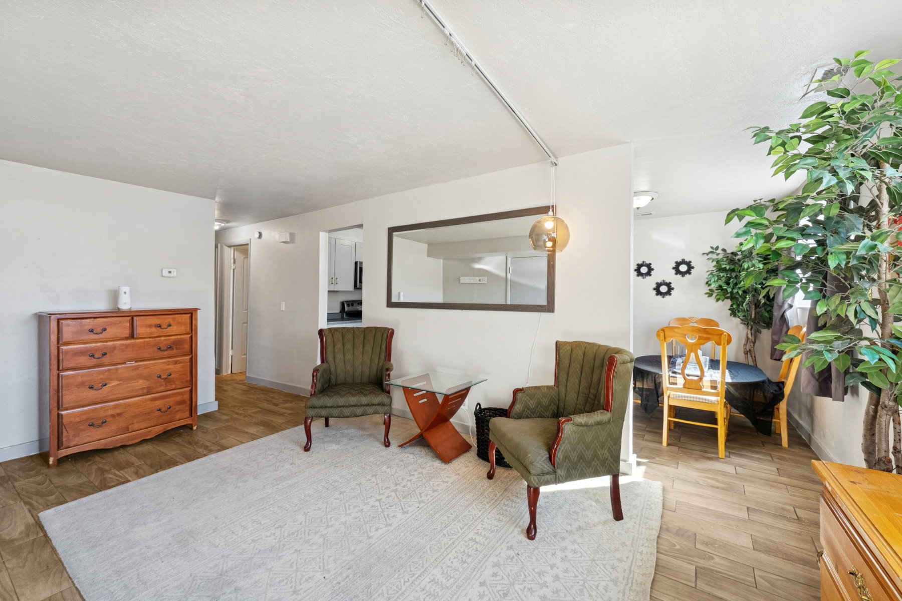 Spacious interior featuring light-toned walls and wood-finish flooring