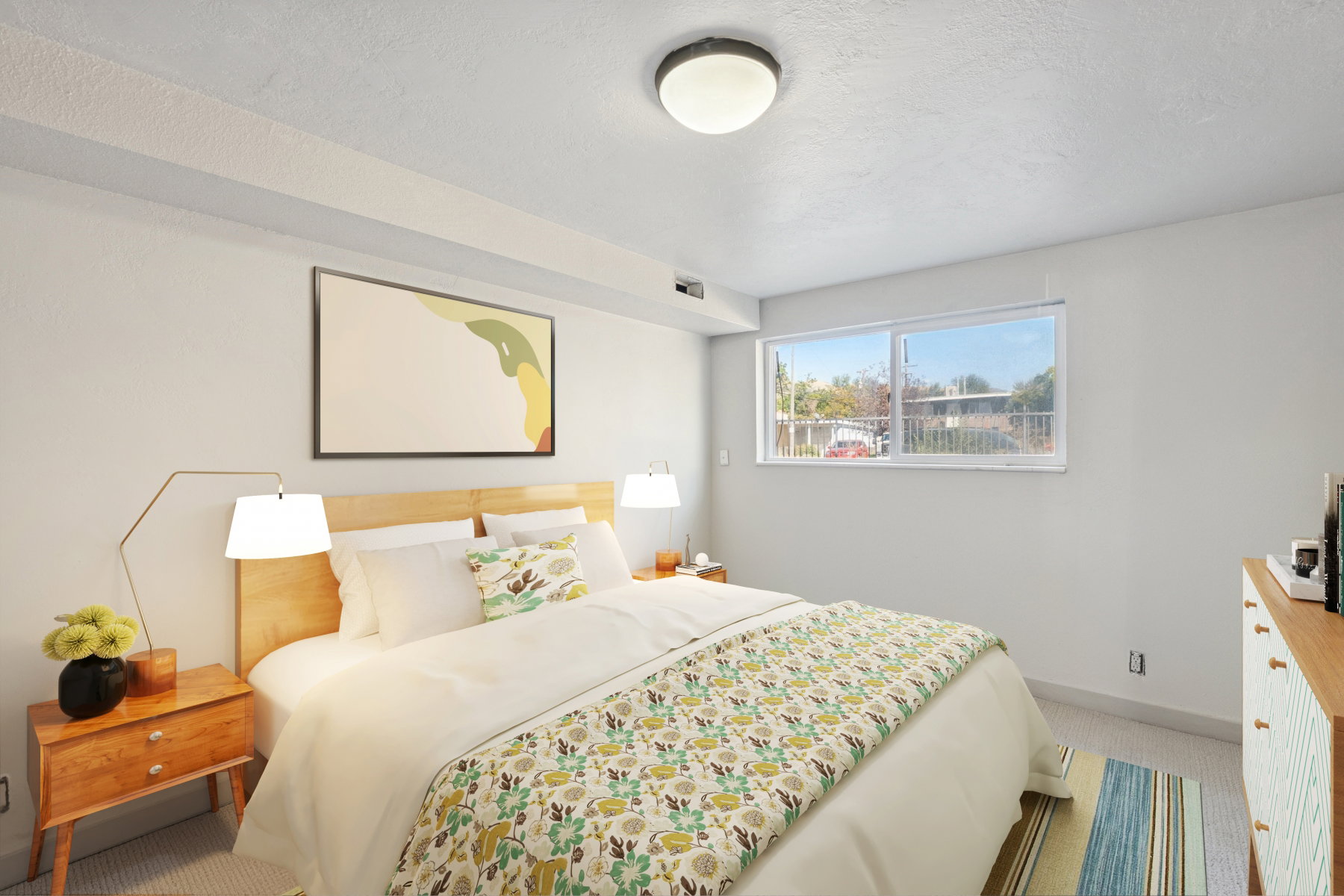 Bright room featuring a large horizontal window and recessed ceiling beams