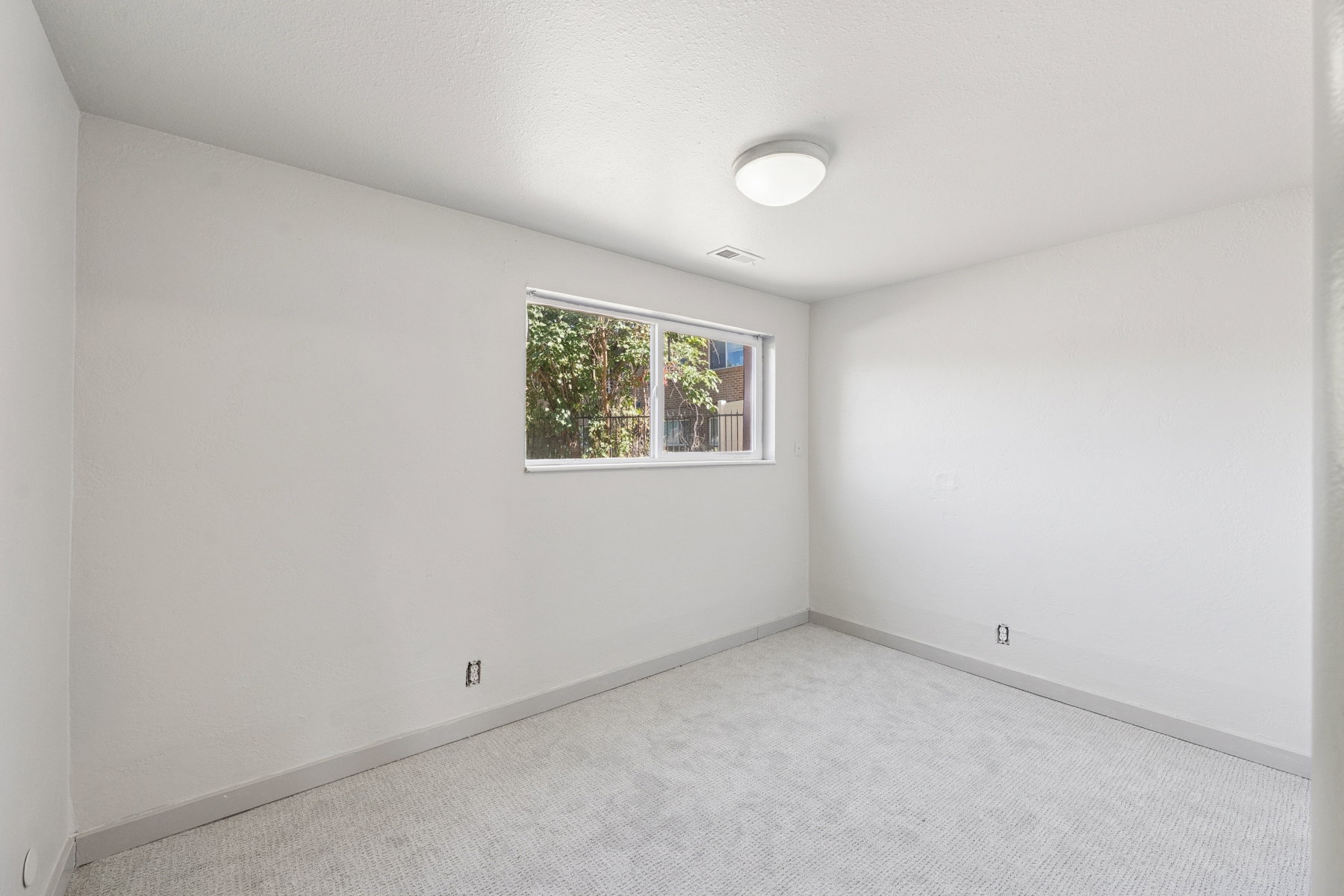 Room featuring light gray carpeting and white painted walls