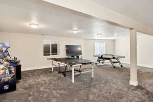 Spacious recreational room featuring recessed lighting, neutral wall tones, and plush carpeting