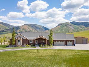 Expansive front lawn with a paved circular driveway