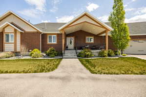 Brick facade with shingle roofing and complementary siding accents