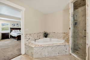 Corner soaking tub with stone-look surround and deck-mounted faucet