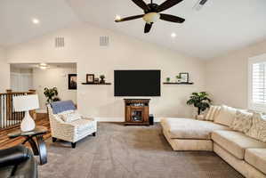 Vaulted ceiling living area featuring recessed lighting and a ceiling fan