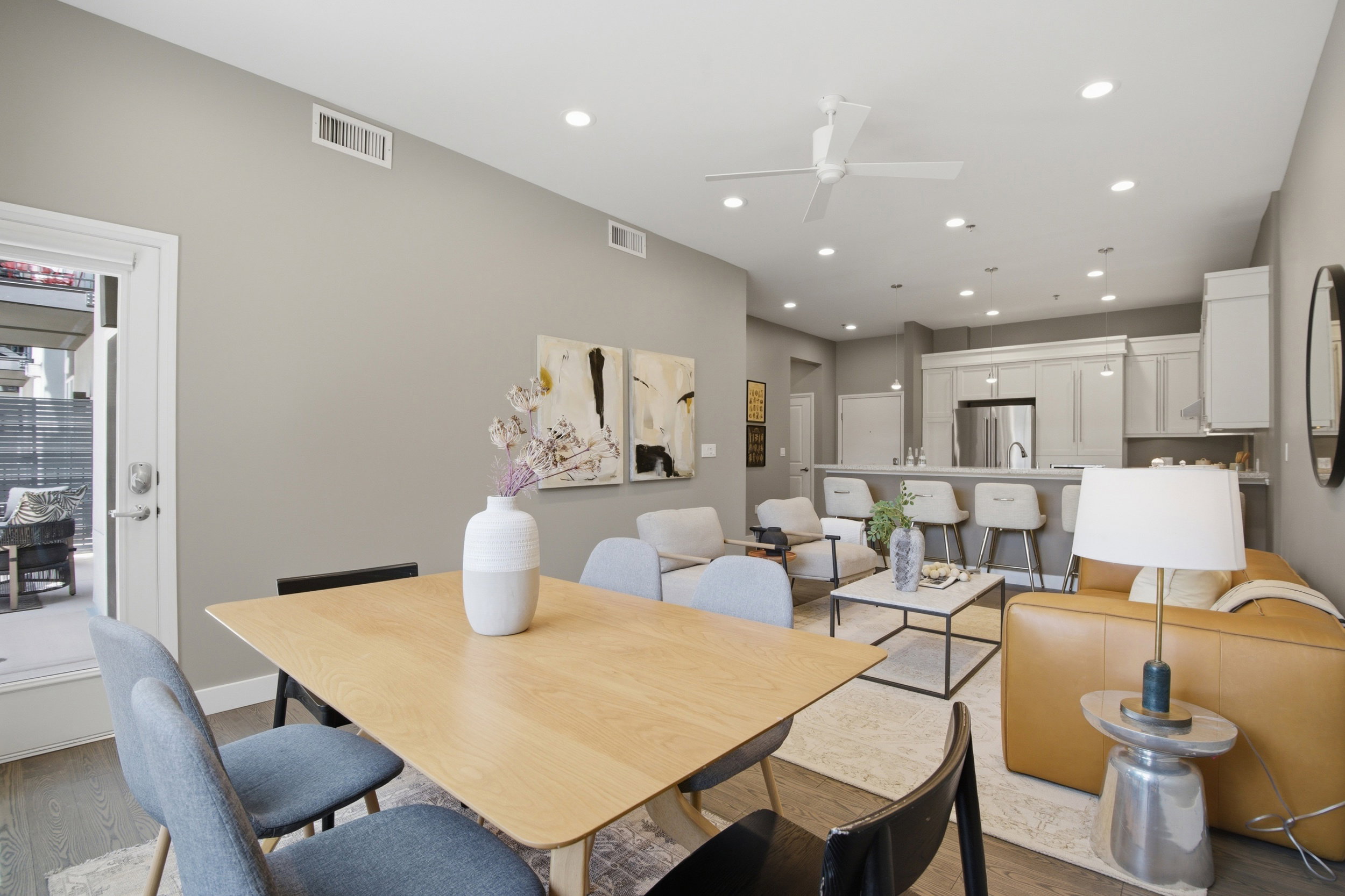 Open-concept living space with wood-finish flooring, recessed lighting, and a modern ceiling fan