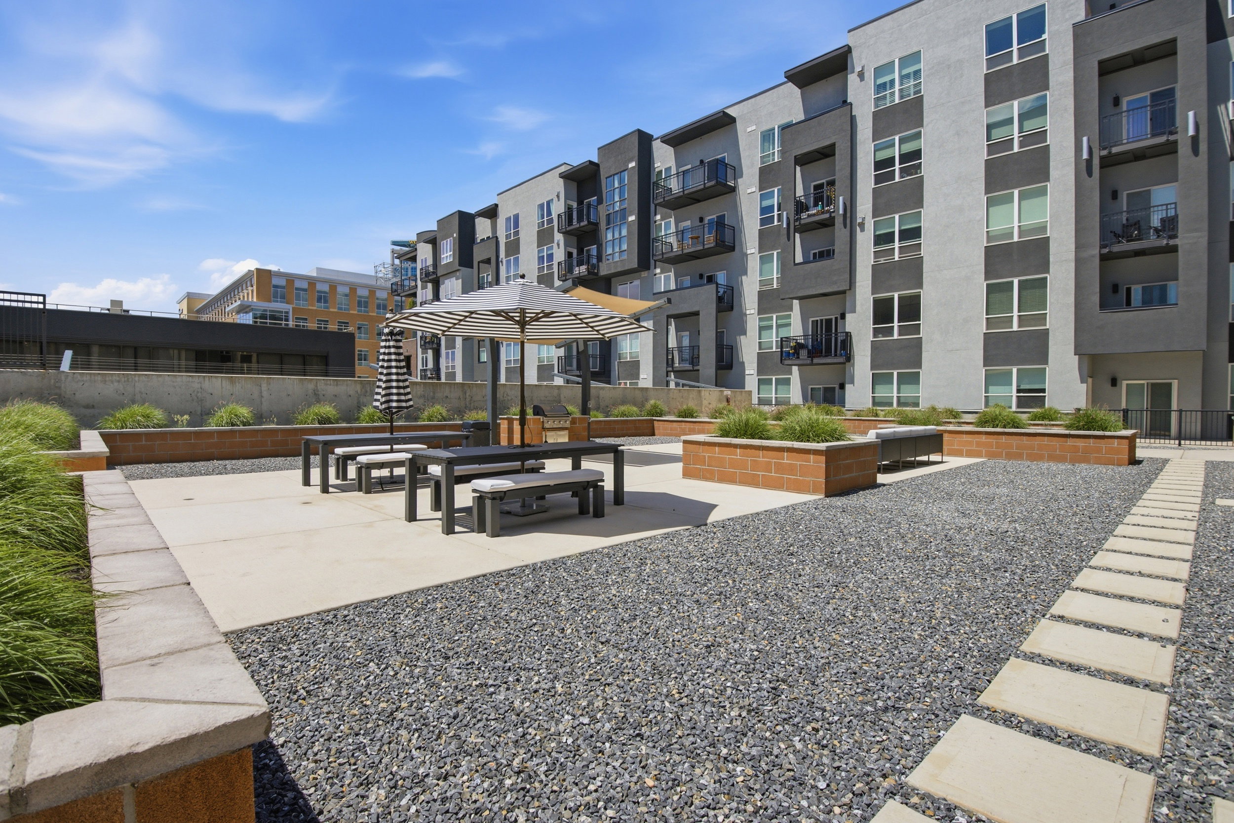 Outdoor patio area with concrete pavers and gravel landscaping