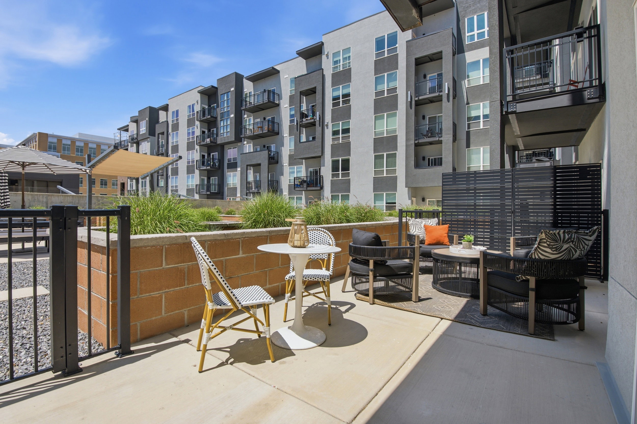 Private patio space featuring concrete paving and a black slatted privacy screen