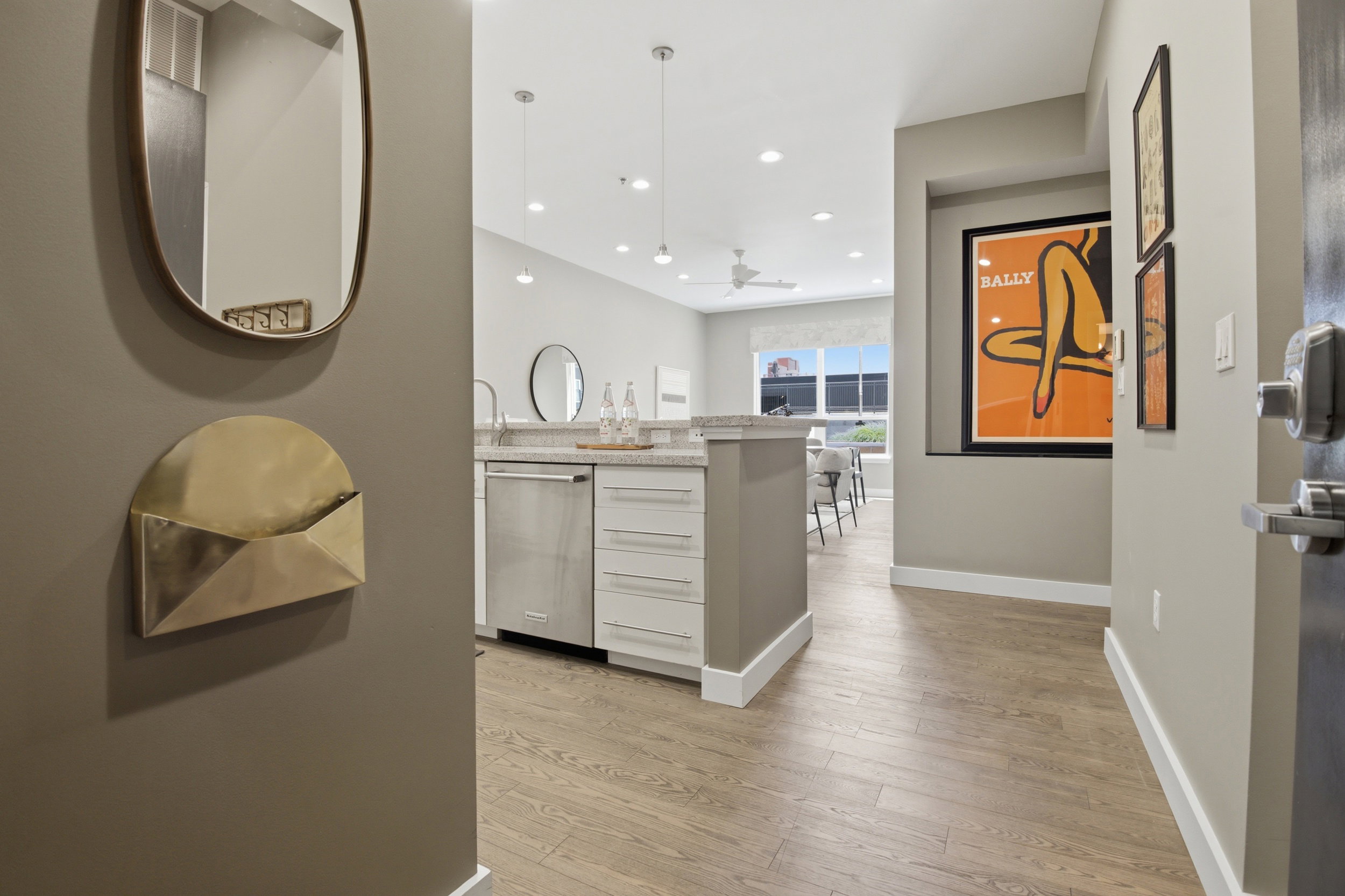 Modern open-concept living area featuring wood-finish flooring, recessed lighting, and a contemporary ceiling fan