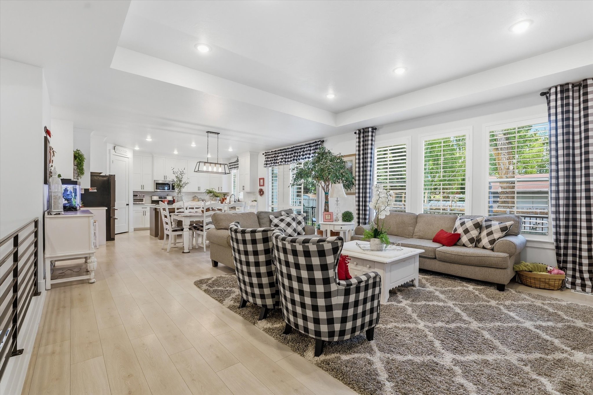 Open-concept living space featuring wood-finish flooring and recessed lighting
