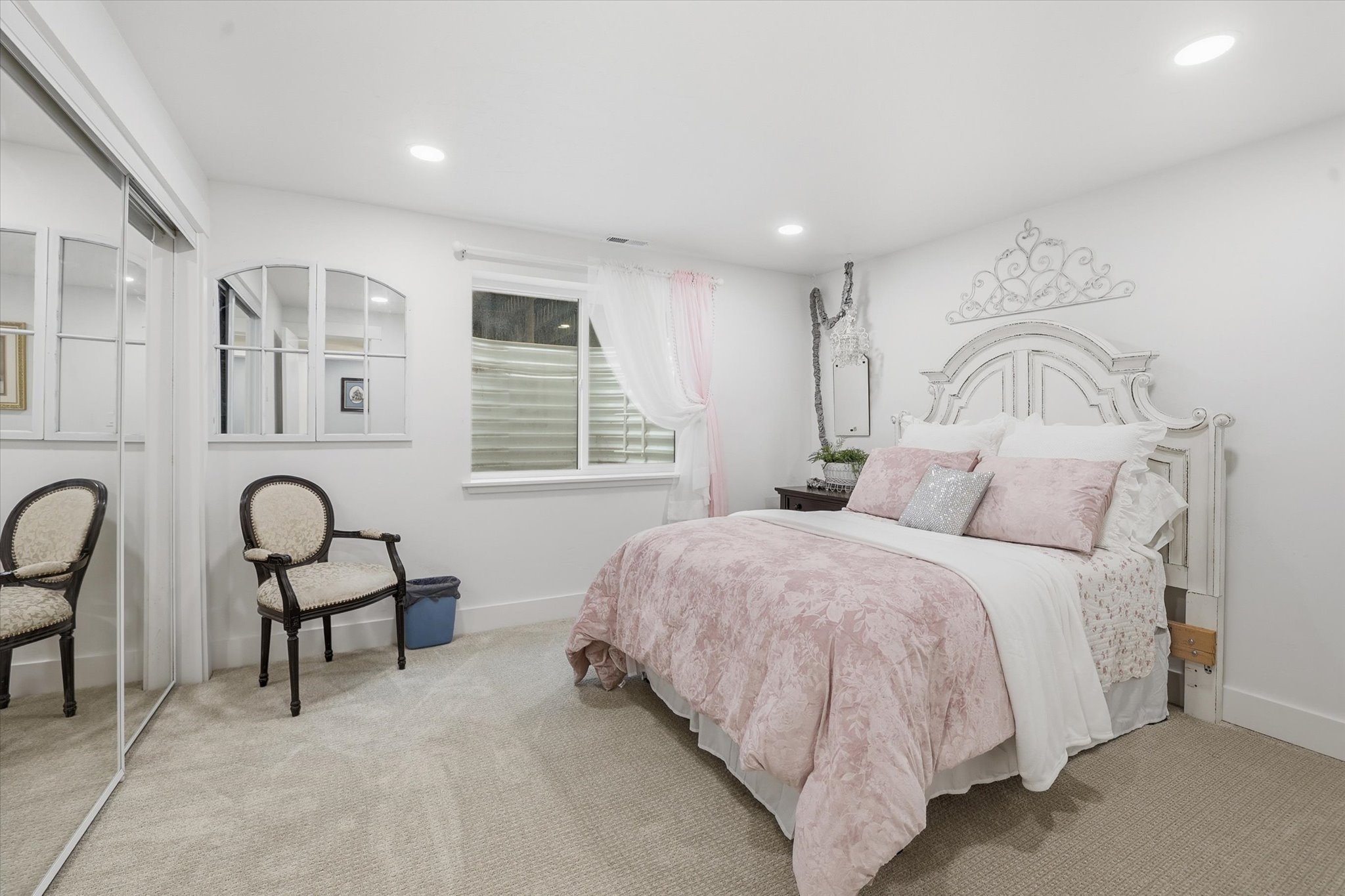 Carpeted bedroom featuring recessed lighting, a window with horizontal blinds, and a mirrored closet door