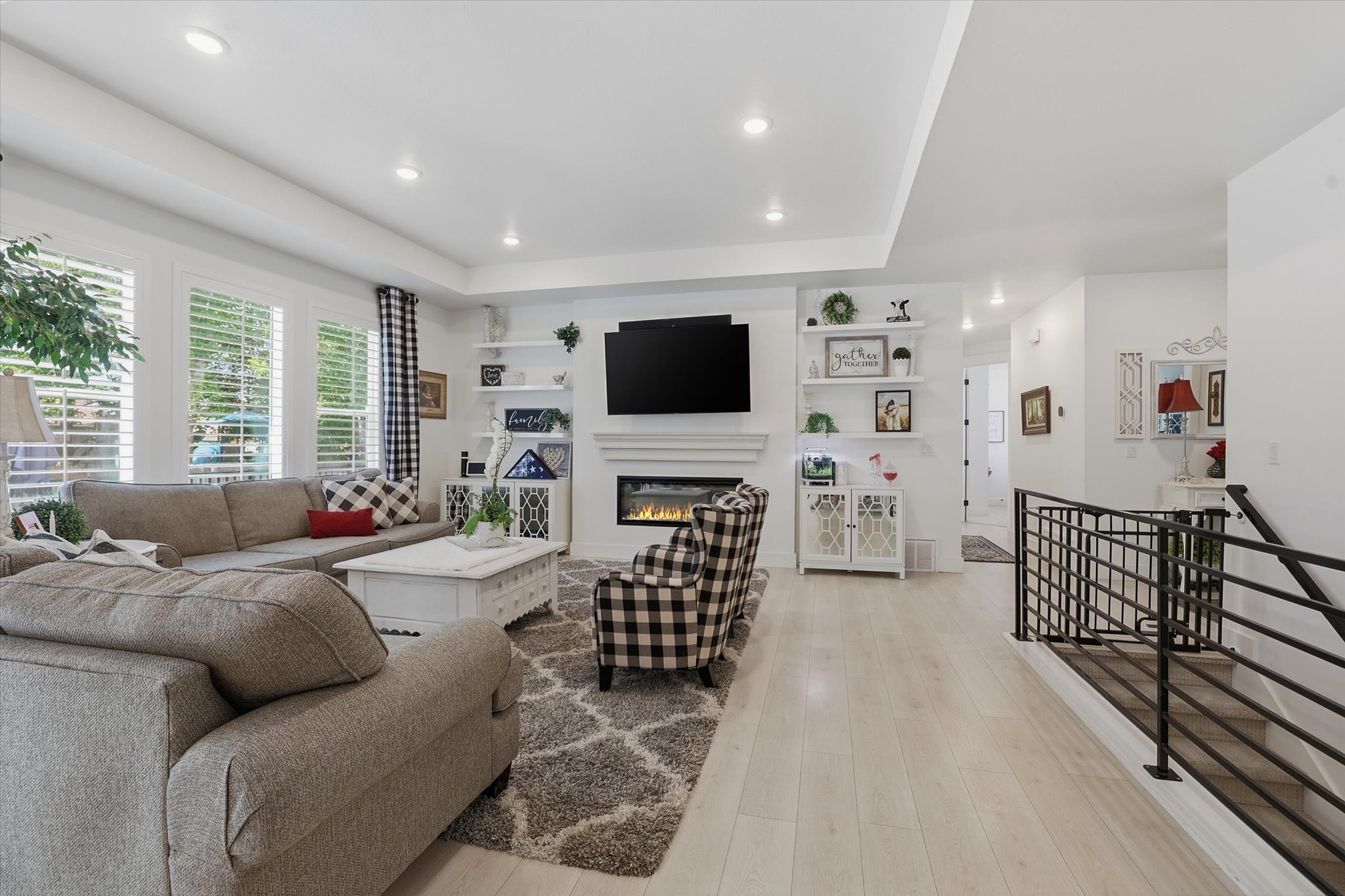 Bright living area featuring wood-finish flooring and a central fireplace