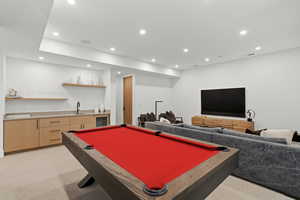 Entertainment room featuring pool table, sitting area, recessed lighting, and wet bar