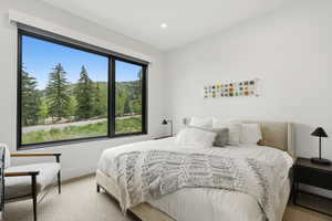Expansive picture window framing a wooded landscape