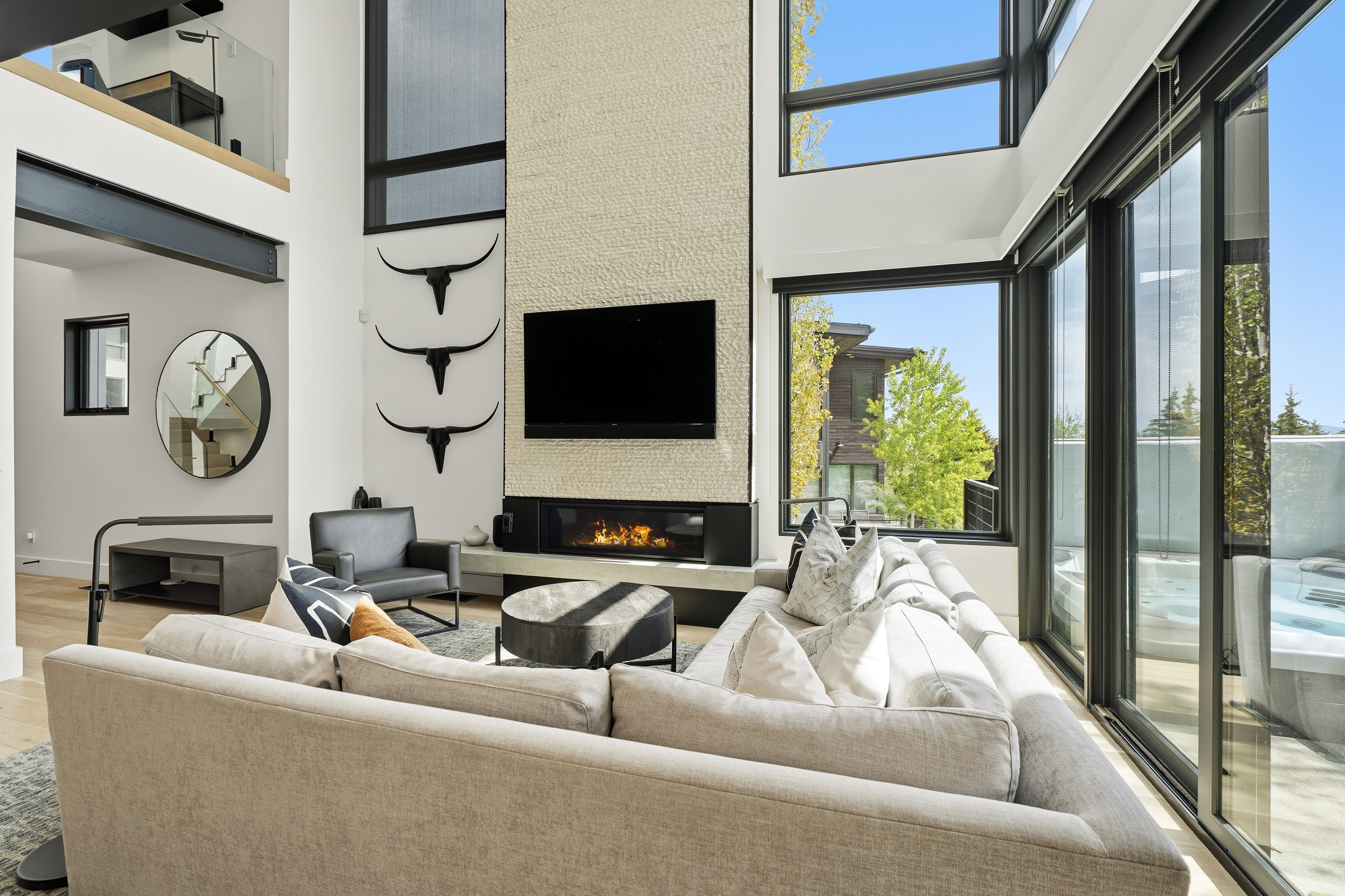 Living area with a two-story textured fireplace wall and linear fireplace