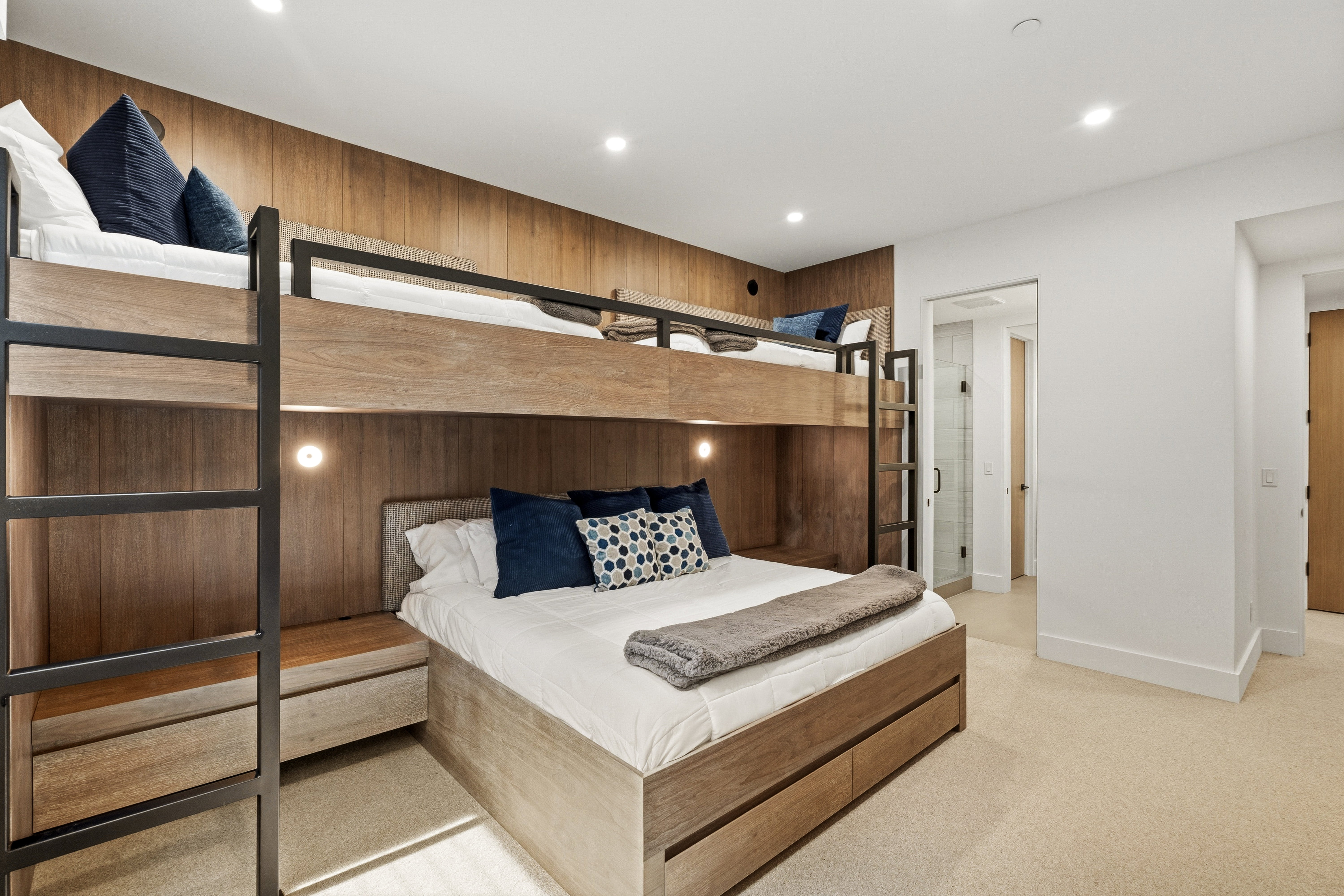 Integrated bunk beds featuring wood-finish paneling and black metal accents