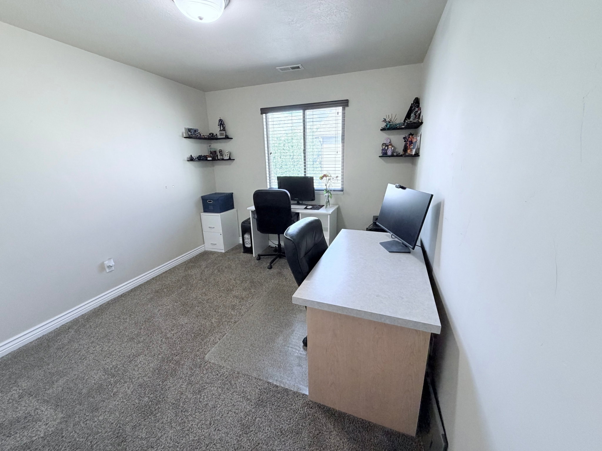 Bedroom #3 or home office with light walls and neutral carpeting