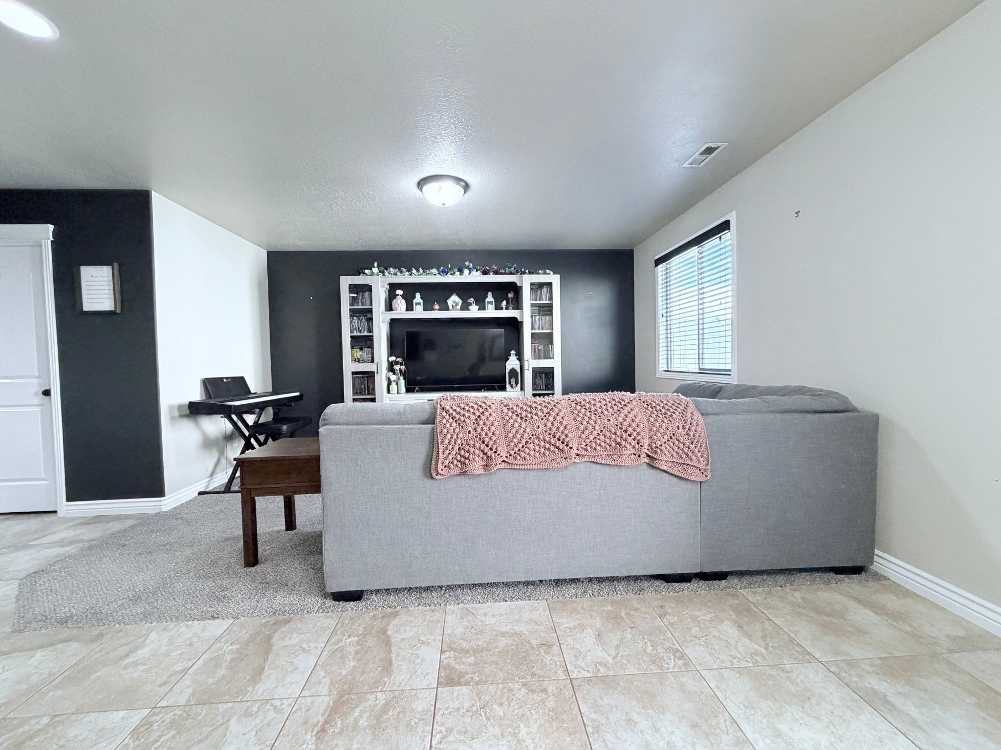Spacious living area featuring a dark accent wall