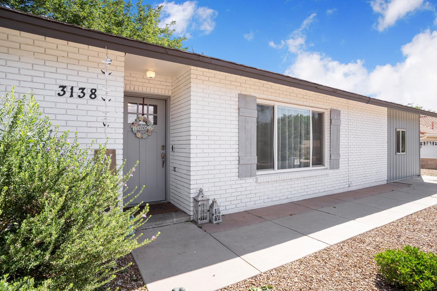 White painted brick exterior with dark trim