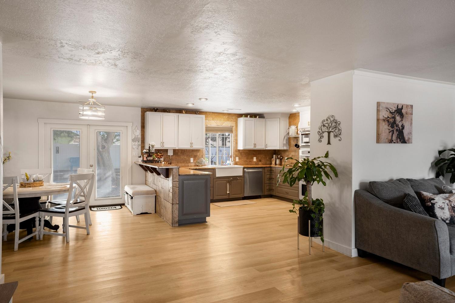 Open-concept kitchen and dining area featuring light wood-finish flooring